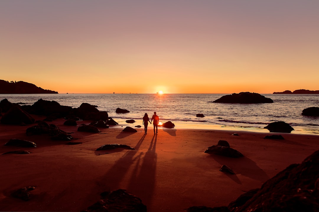 Travelers enjoying a pristine beach at sunset